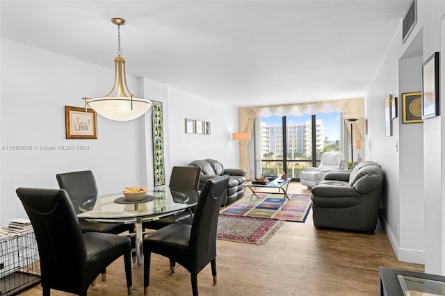1600 S Ocean Dr Unit 5J, Hollywood, FL 33019 - dining room with wood finished floors, expansive windows, and baseboards