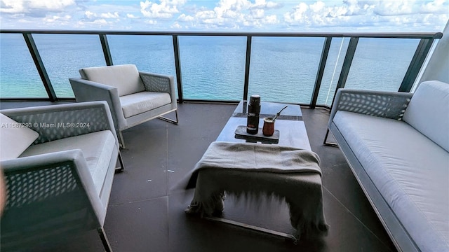 balcony with outdoor lounge area and a water view