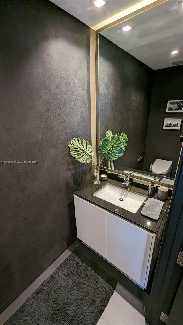 bathroom featuring vanity and toilet