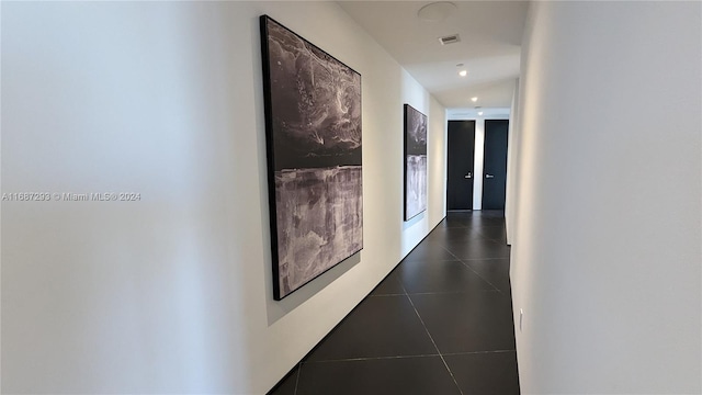 corridor featuring french doors and dark tile patterned flooring