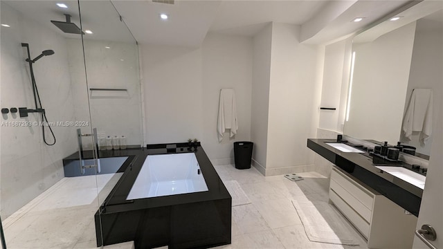 bathroom featuring vanity and tiled shower