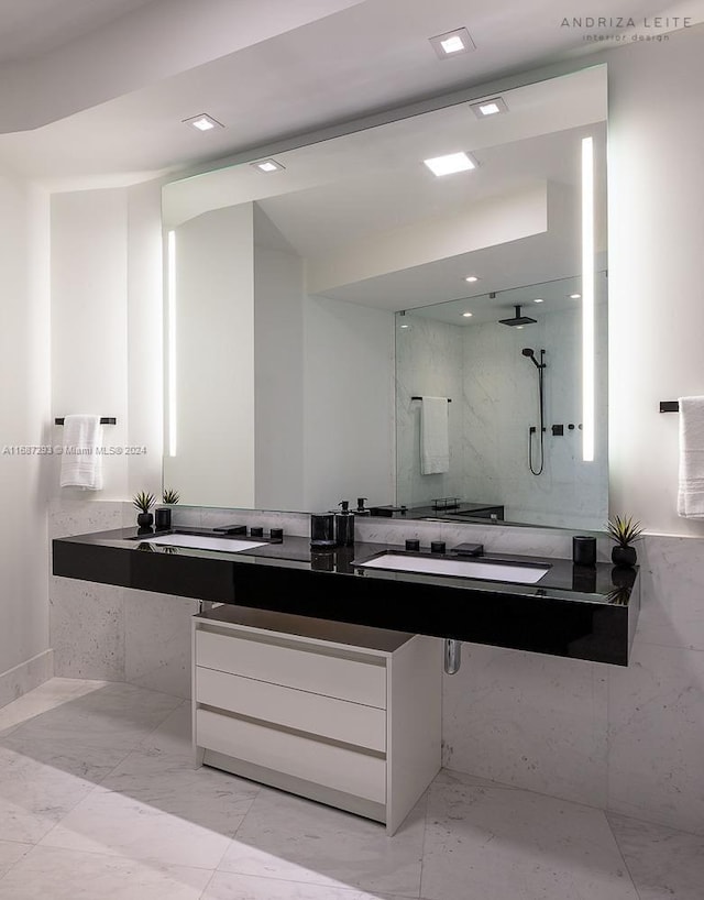 bathroom featuring vanity and tiled shower