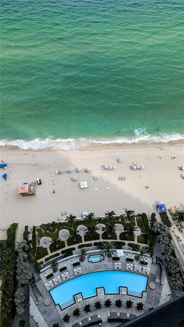 drone / aerial view featuring a water view and a beach view