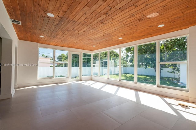 unfurnished sunroom with wooden ceiling and a wealth of natural light