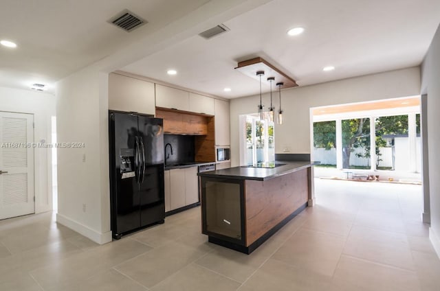 kitchen featuring black appliances, a center island, pendant lighting, light tile patterned floors, and white cabinetry