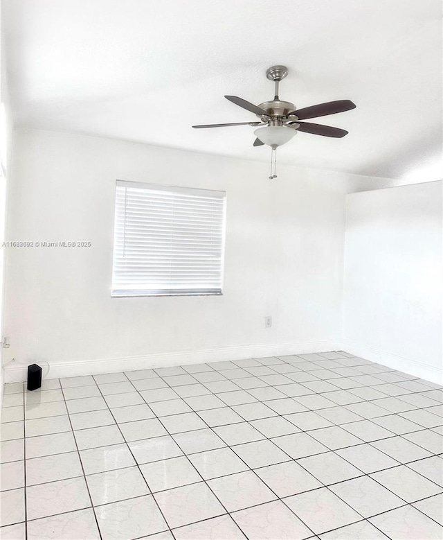 spare room featuring ceiling fan and light tile patterned flooring