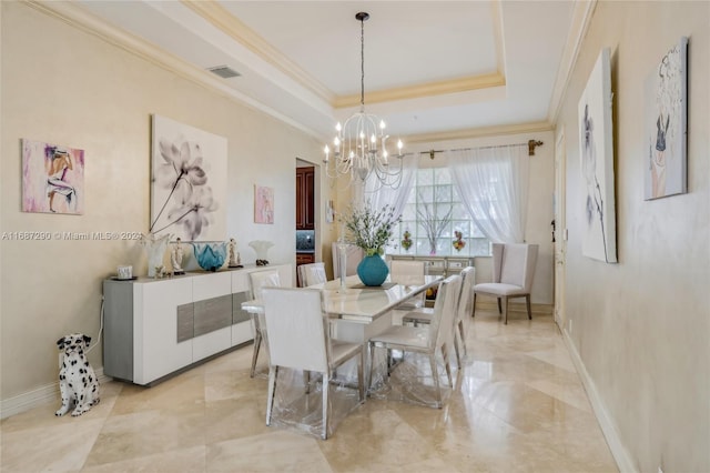 dining room with an inviting chandelier, crown molding, and a raised ceiling