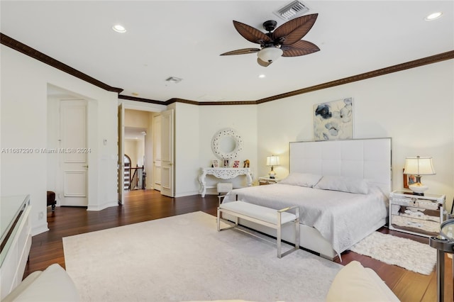 bedroom with crown molding, dark wood-type flooring, and ceiling fan