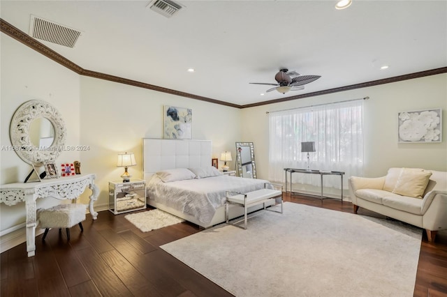 bedroom featuring dark hardwood / wood-style flooring, ornamental molding, and ceiling fan