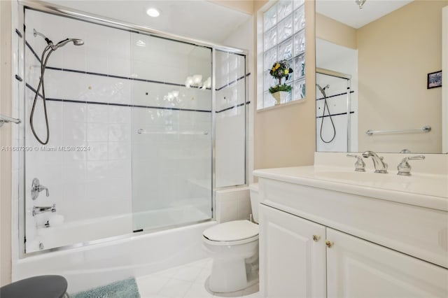 full bathroom featuring toilet, combined bath / shower with glass door, vanity, and tile patterned flooring