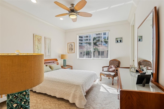 bedroom with ornamental molding, carpet, and ceiling fan