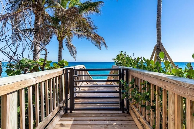 exterior space featuring a deck with water view