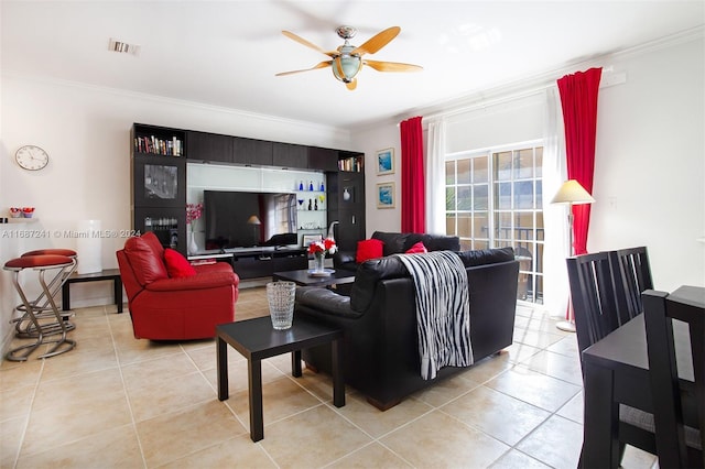 living room with crown molding, light tile patterned flooring, and ceiling fan