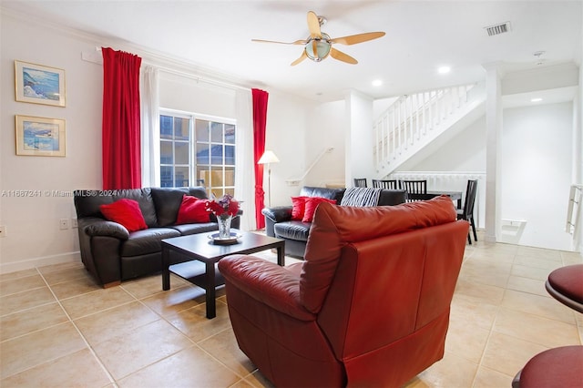 tiled living room with ornamental molding and ceiling fan