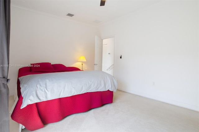 bedroom featuring crown molding, carpet, and ceiling fan