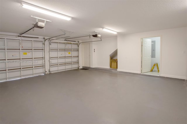 garage featuring a garage door opener and electric panel