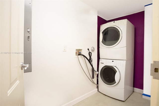 laundry area featuring stacked washing maching and dryer