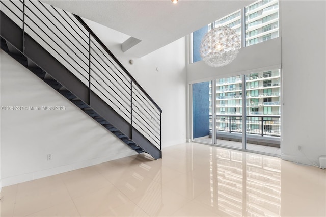 stairs featuring a chandelier and tile patterned floors