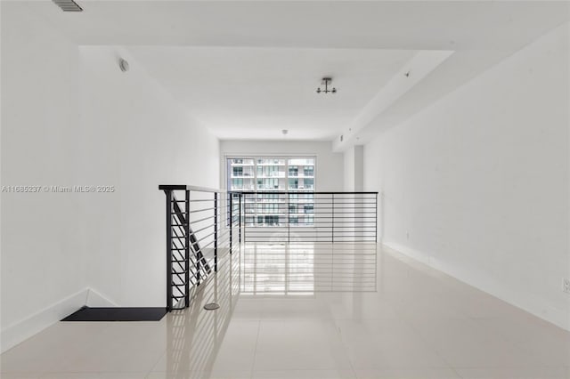 hall featuring light tile patterned floors