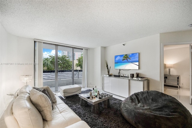 living room featuring a textured ceiling and floor to ceiling windows