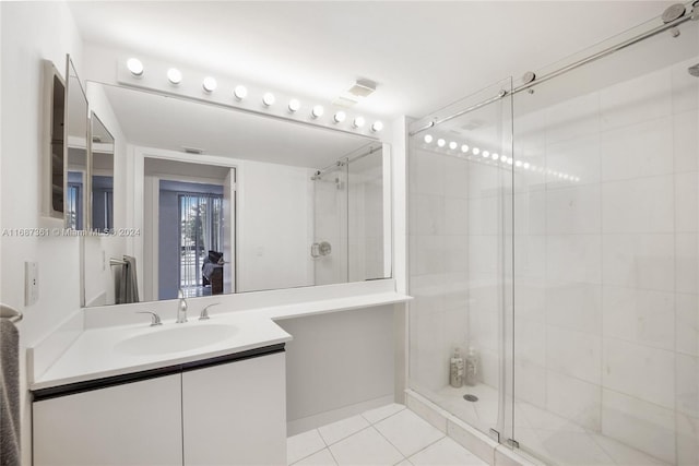 bathroom featuring vanity, tile patterned floors, and a shower with door