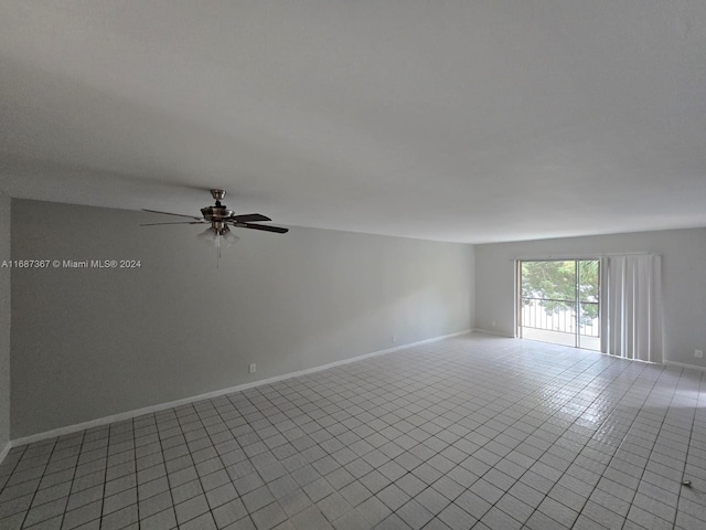 tiled spare room with ceiling fan