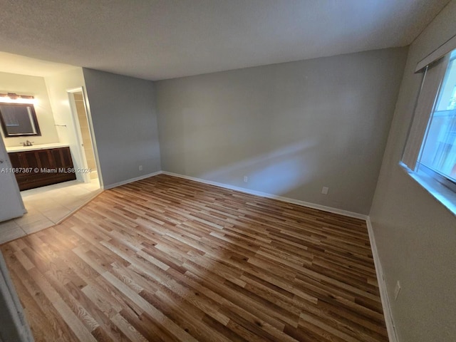 interior space with a textured ceiling and light hardwood / wood-style floors