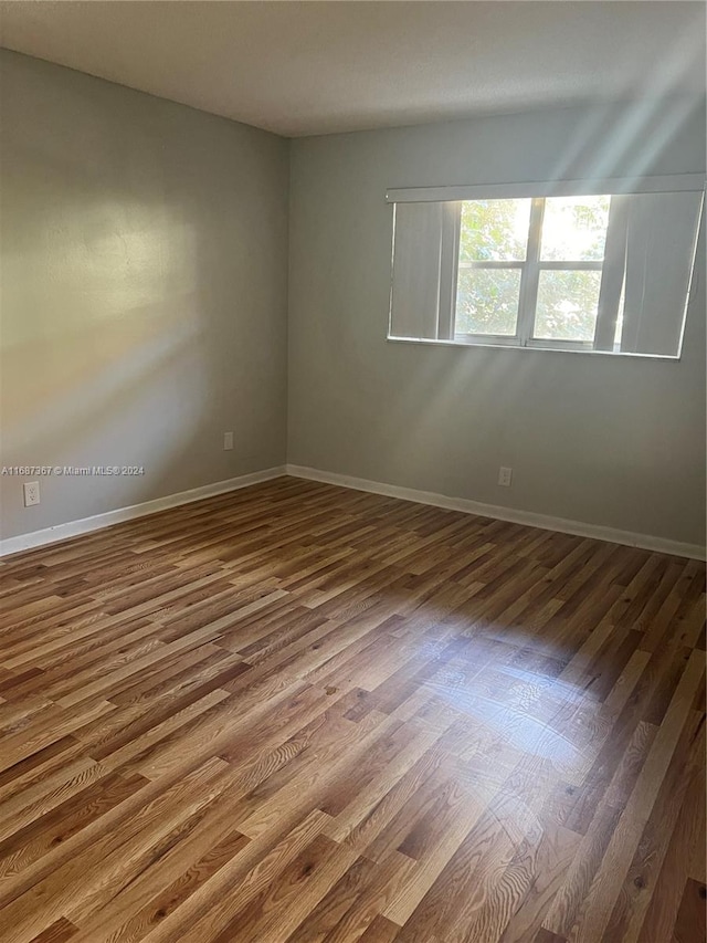 unfurnished room featuring hardwood / wood-style floors