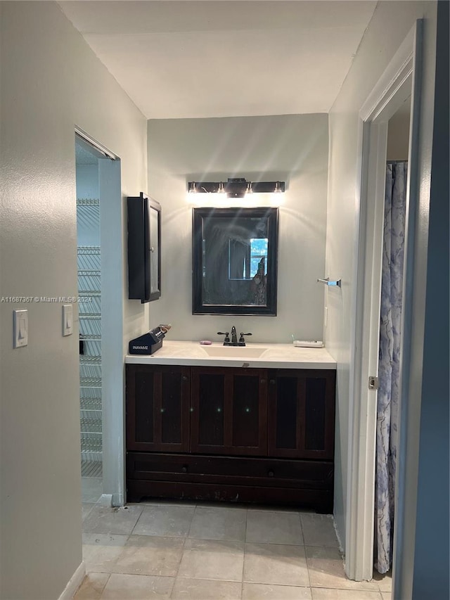 bathroom featuring vanity, tile patterned flooring, and walk in shower