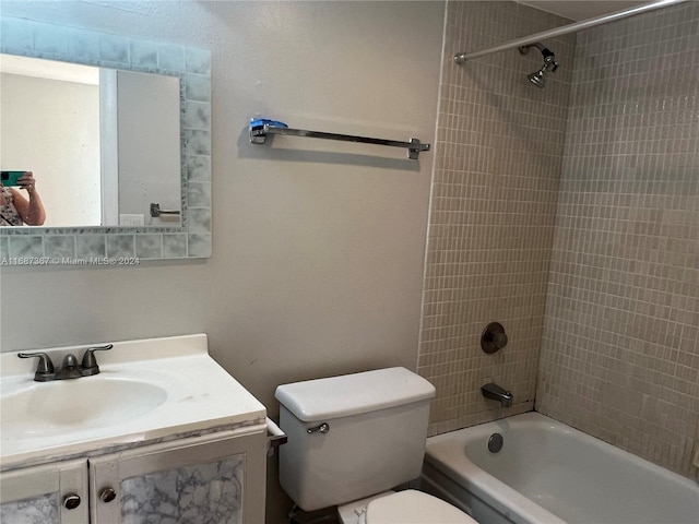 full bathroom with vanity, tiled shower / bath combo, and toilet