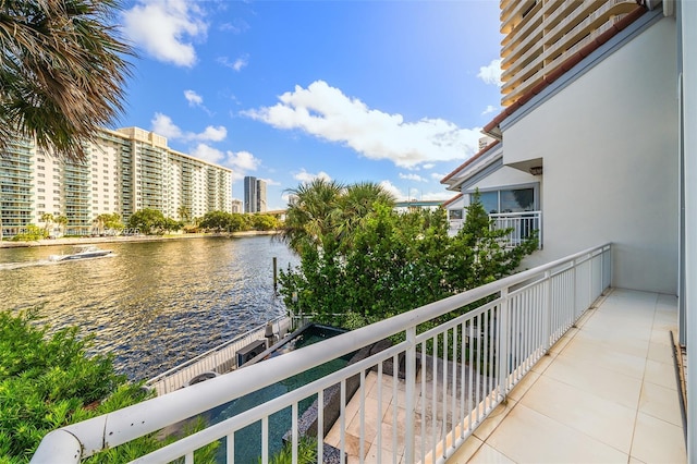 balcony with a water view and a city view