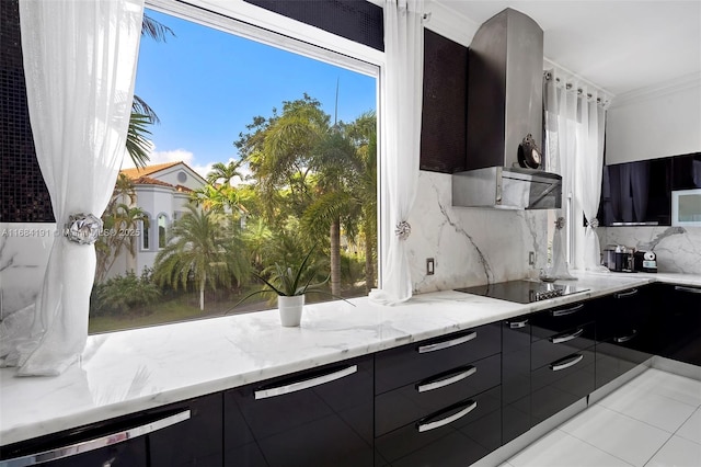 kitchen with black electric cooktop, dark cabinets, decorative backsplash, light stone countertops, and modern cabinets