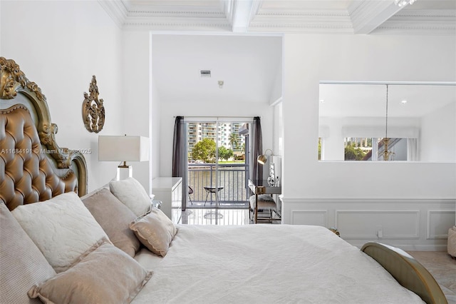 bedroom featuring visible vents, beamed ceiling, access to exterior, crown molding, and a decorative wall