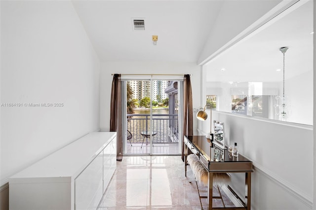 entryway featuring lofted ceiling, marble finish floor, and visible vents