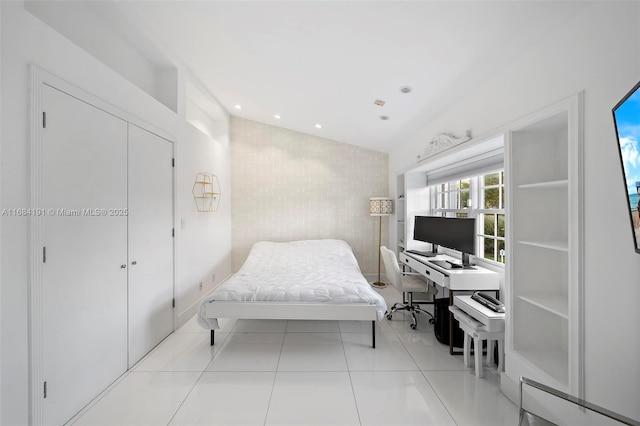 bedroom with light tile patterned floors, a closet, and recessed lighting