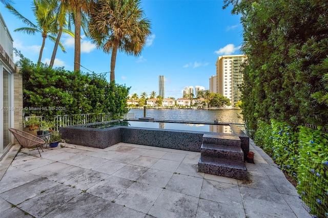 view of patio with a view of city and a water view