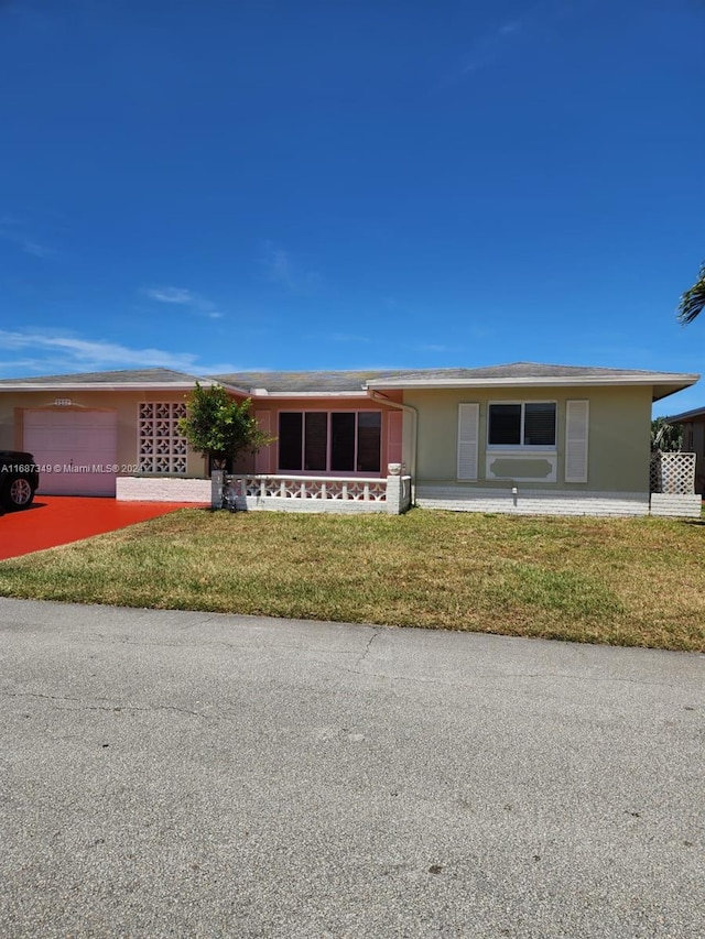 ranch-style home with a front yard and a garage