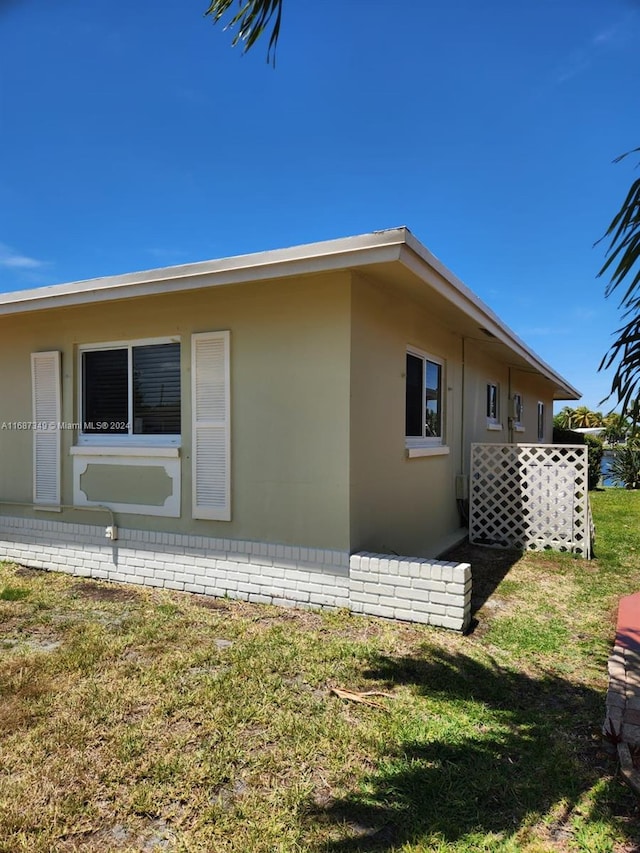 view of property exterior with a yard