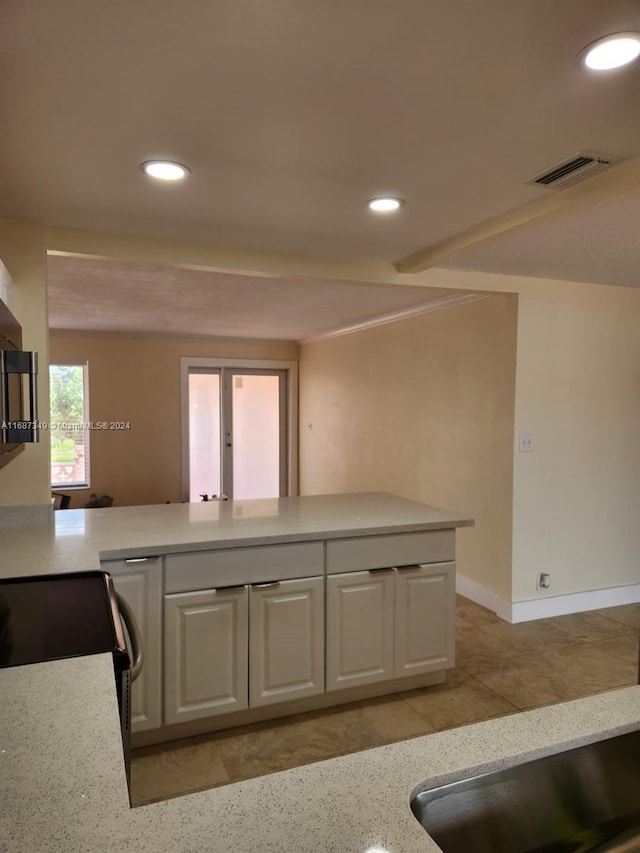 kitchen with stainless steel range oven and white cabinets