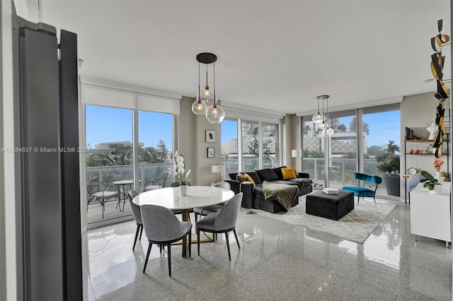 dining space featuring a wealth of natural light and a notable chandelier