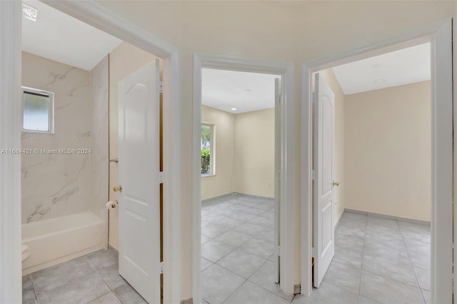 hallway with light tile patterned floors