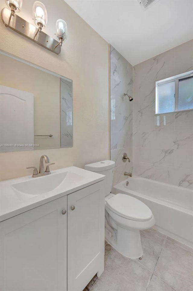 full bathroom with vanity, tiled shower / bath combo, and toilet