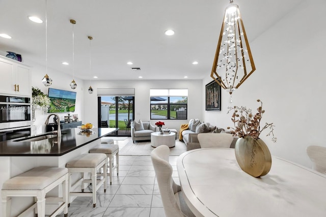 dining area featuring recessed lighting and marble finish floor