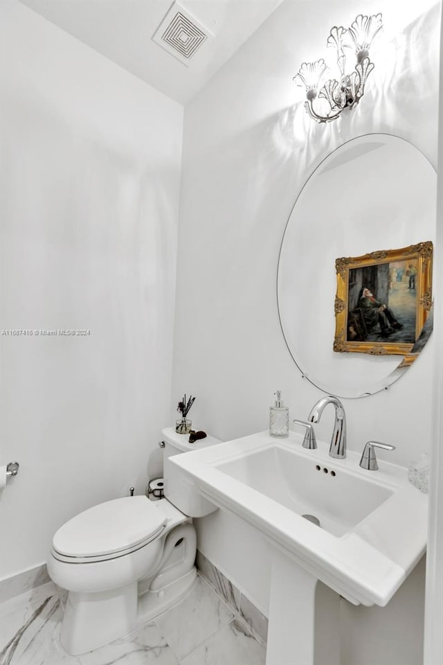 bathroom featuring toilet and sink