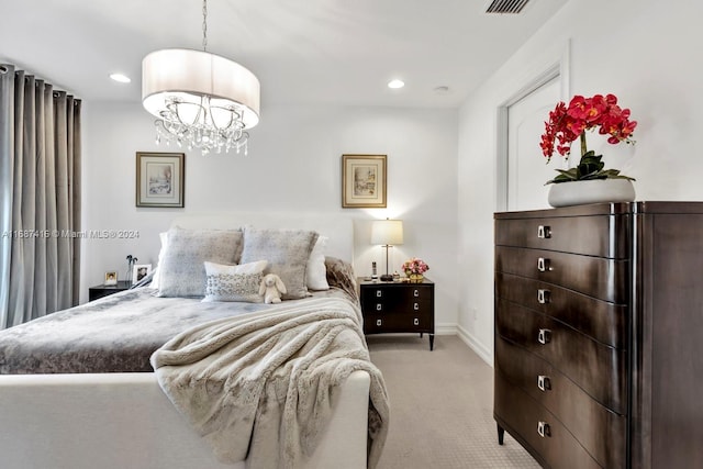 bedroom with light colored carpet and an inviting chandelier