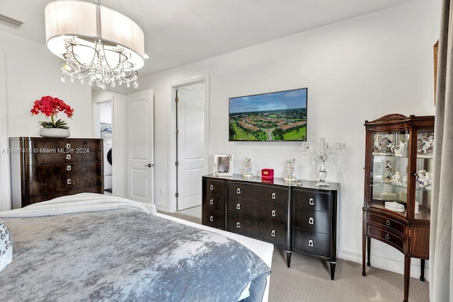 bedroom with light carpet and a chandelier