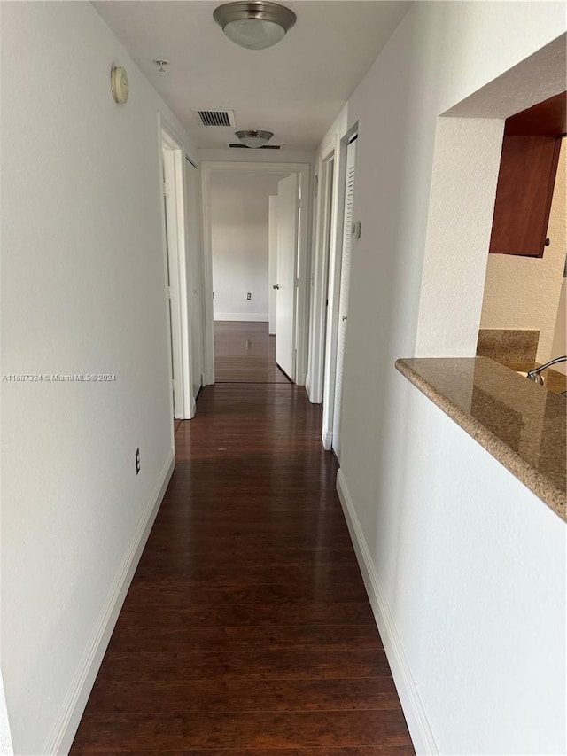 corridor featuring dark wood-type flooring