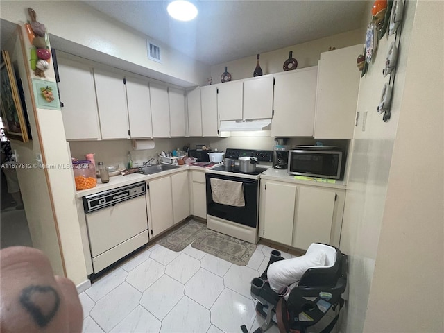 kitchen featuring white cabinetry, sink, and white appliances