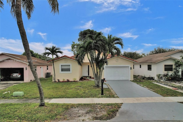 view of front of property with a front yard, a garage, and cooling unit