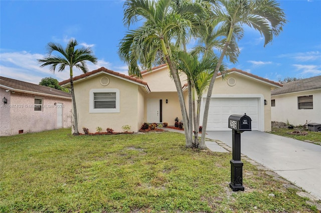 view of front of property with a garage and a front lawn